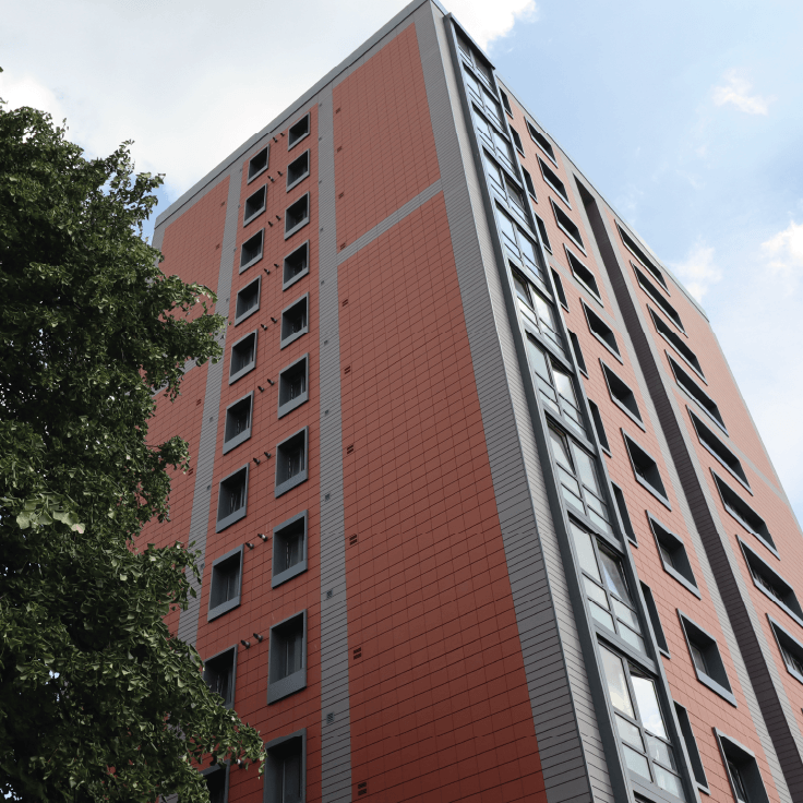 view of a residential tower block from the ground