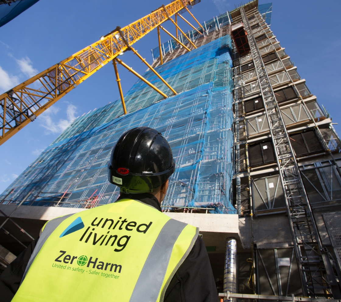 United living employee looking up at newly constructed building