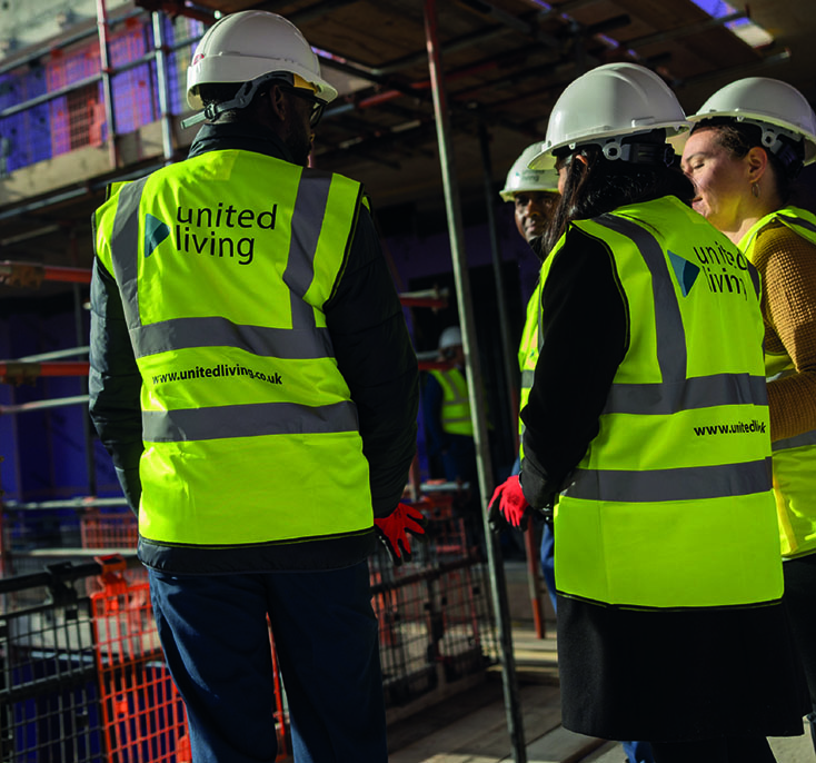 construction workers stood together on site in full ppe