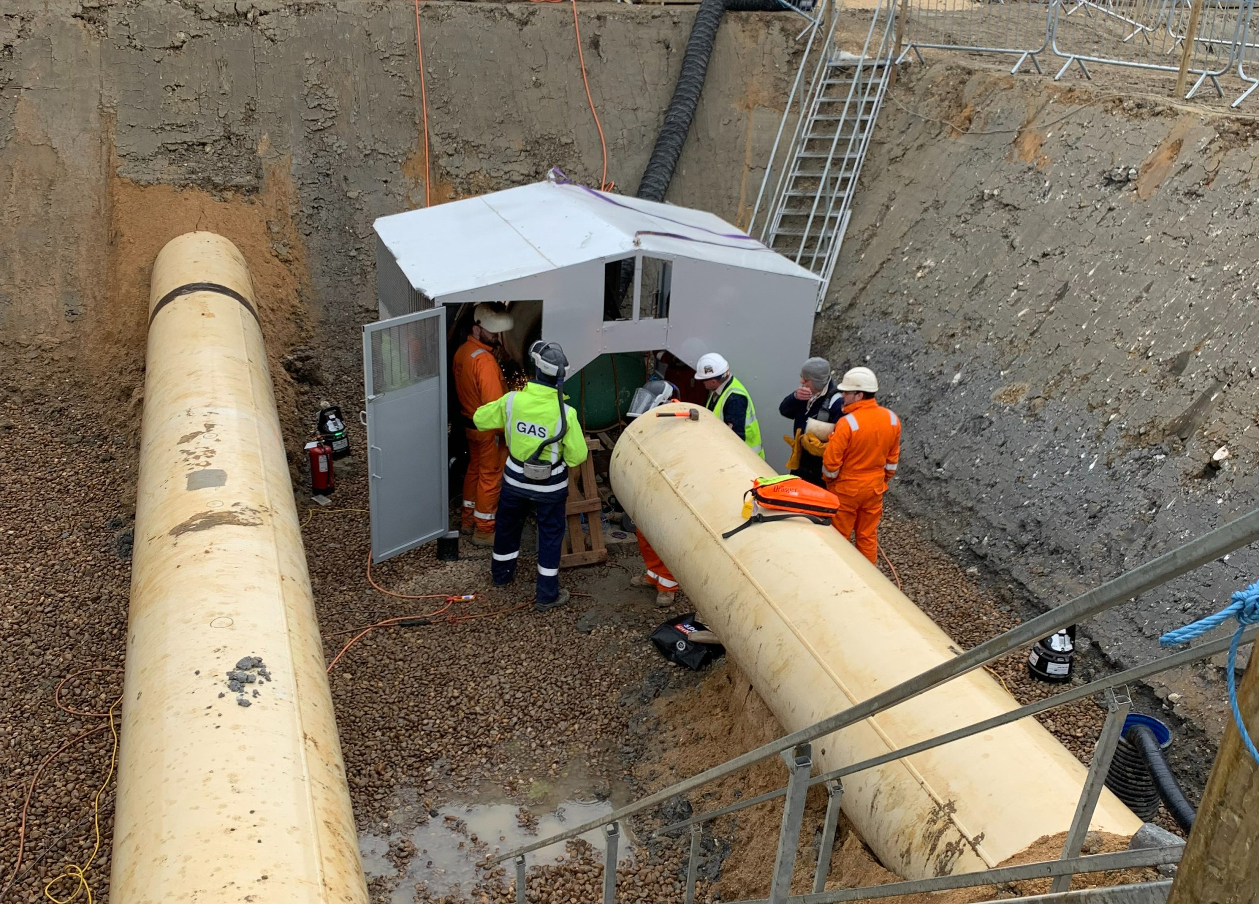 workmen pictured with gas compressor