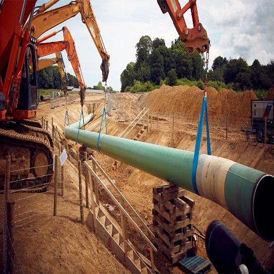 cranes lifting large pipes into ground