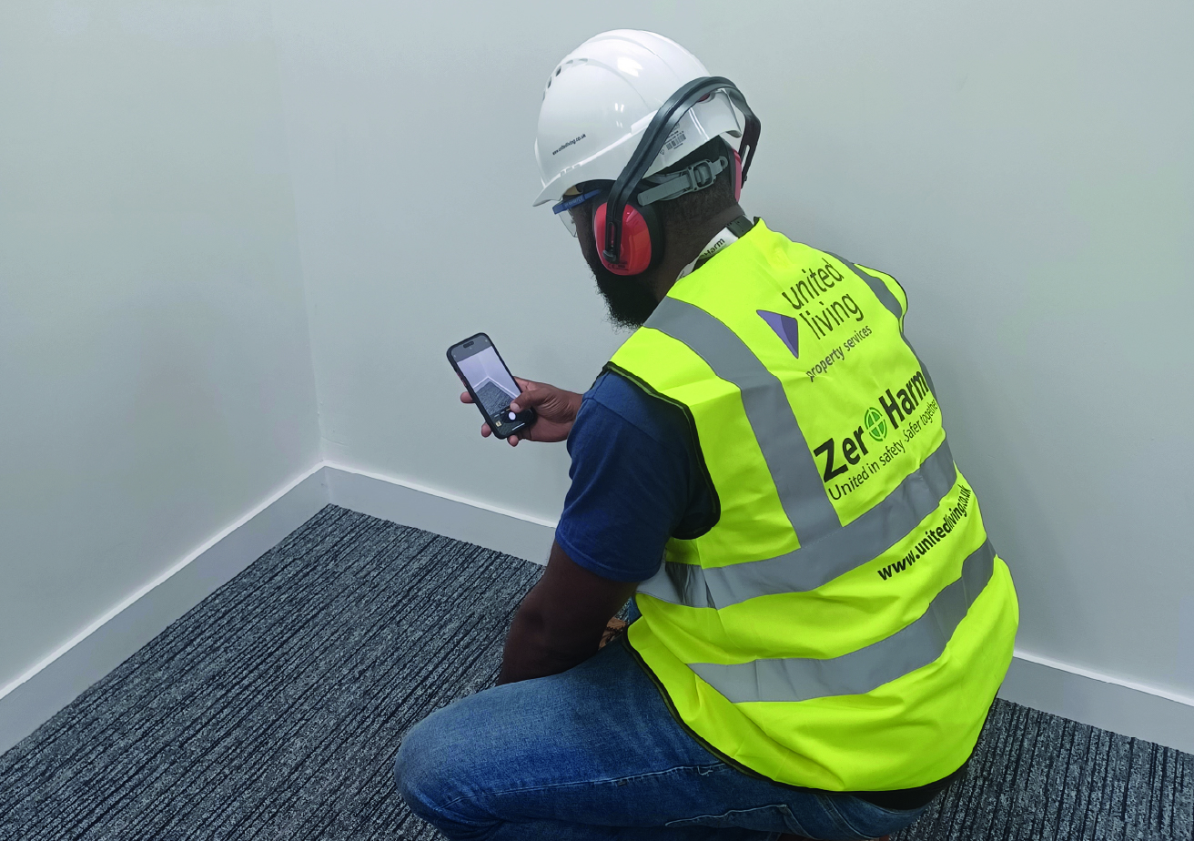 employee checking home for damp