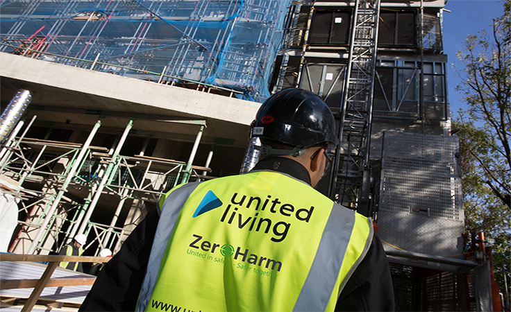 construction worker standing in front of building