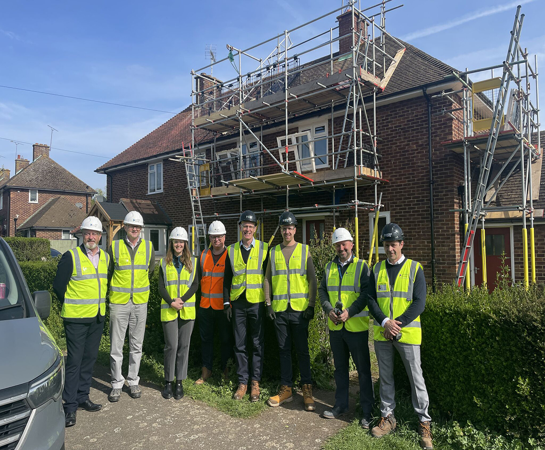 group of clients standing in front of retrofitted house