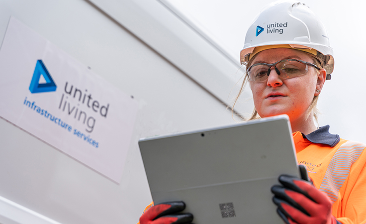 female construction operative holding tablet