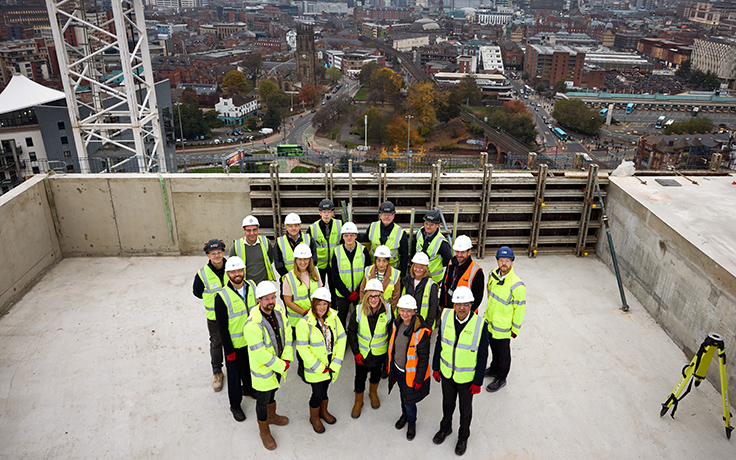construction workers celebrating topping out ceremony of new build development