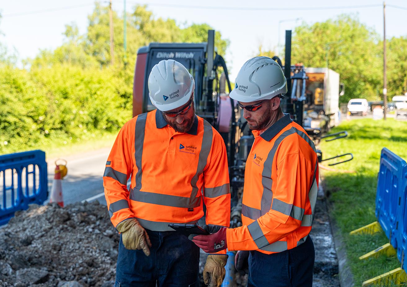 two workers looking at site plans