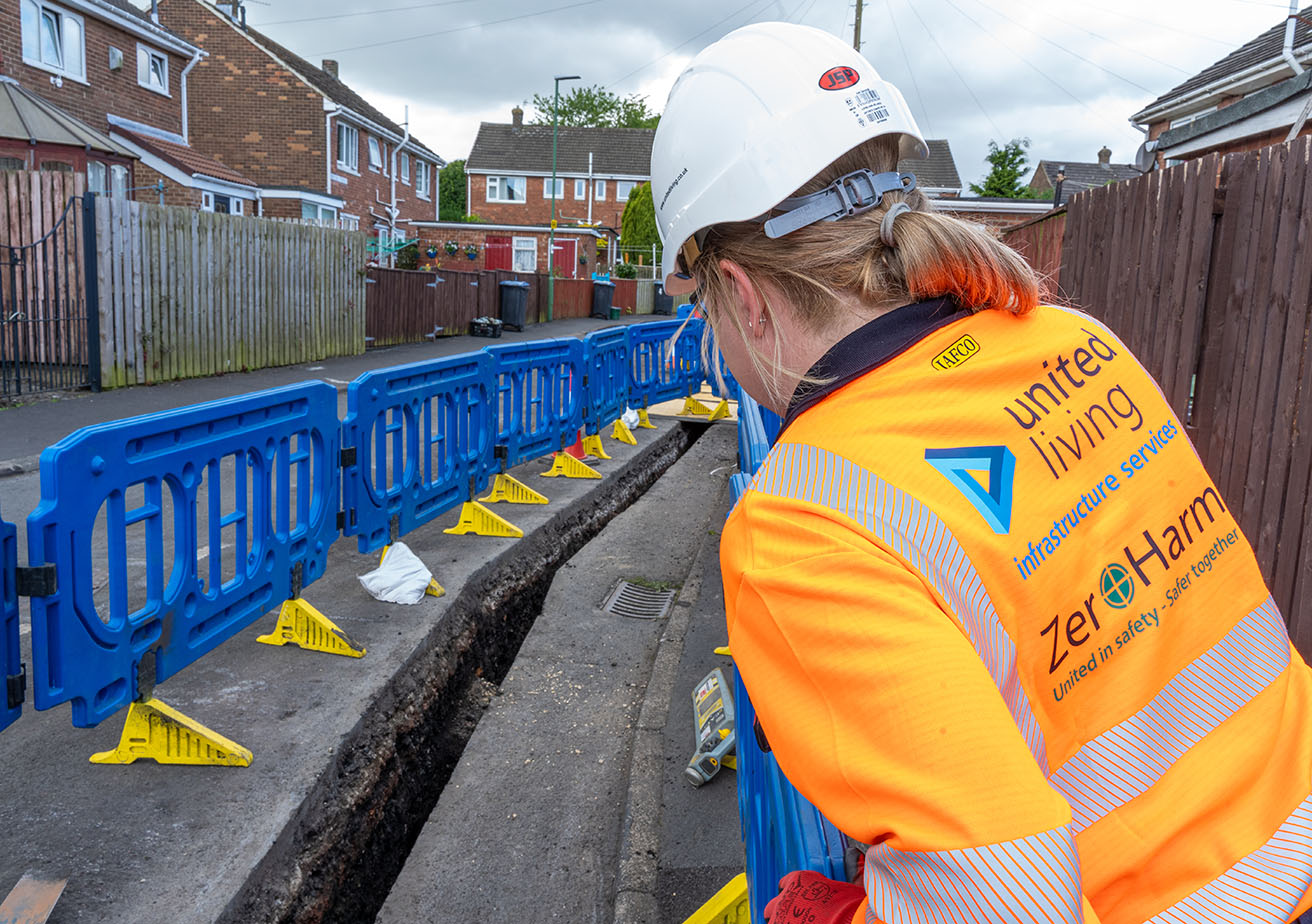 construction worker standing in front of safety barriers